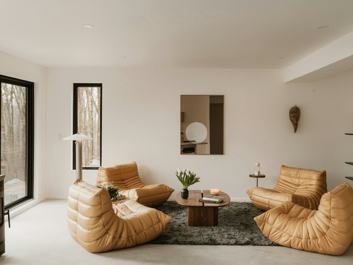 A living room with tan leather chairs